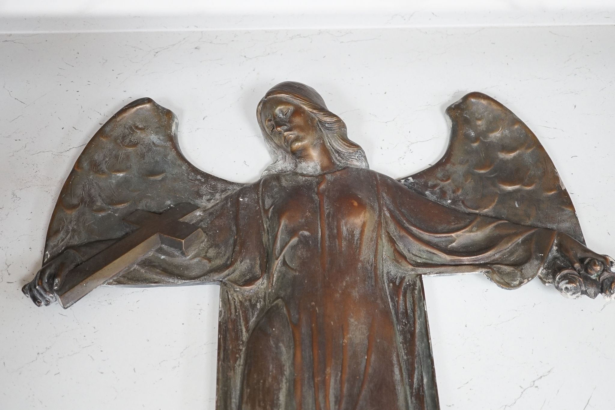 A cast bronze angel, initialled ‘P.D’ to bottom right, 72cm